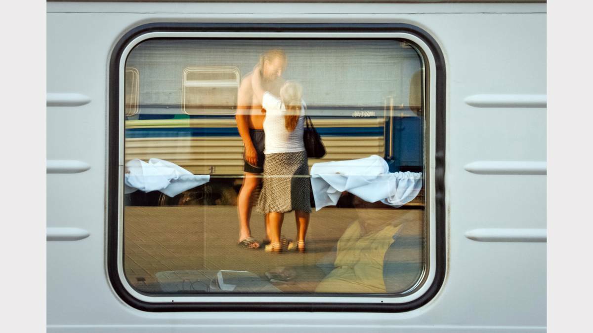  PARKES: Carriage Window by Evgeny Frank, Moscow, Russia – winner of the People in Railway category for In the window carriage taken of a couple reflected through the window of a train at the Kazansky railway station in Moscow.