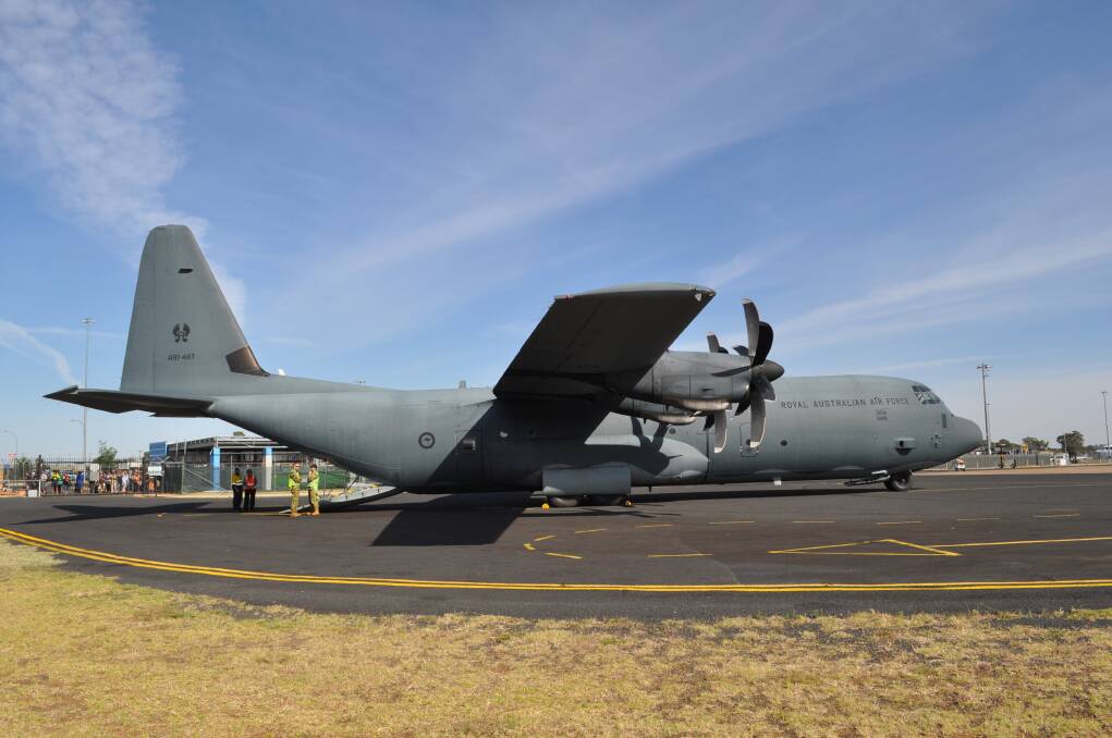Cadets from Dubbo's Squadron 313 file into an Air Force Hercules bound for the Warbirds Downunder air show at Temora on Saturday. Photo: MARK RAYNER