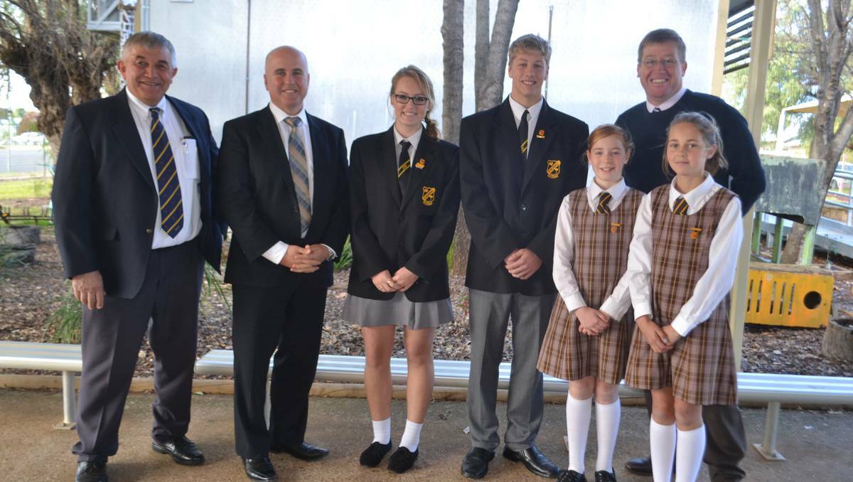 WELLINGTON: Cr Ian Gosper, Minister Adrian Piccoli, Brittany Smith, Grant Iles, Bridget Smith, Sydney Tremain and Member for Dubbo Troy Grant (back) making the announcement that Yeoval will receive a big boost for its school with two new classrooms to replace an ageing timber classroom building.
