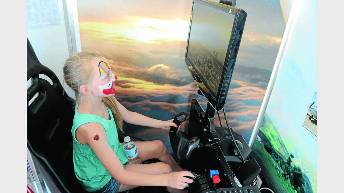 Jenna Redfern certainly had a good time when she went out to the Parkes Airport to check how the record attempt was going. She had her face painted, and then tried out the flight simulator.