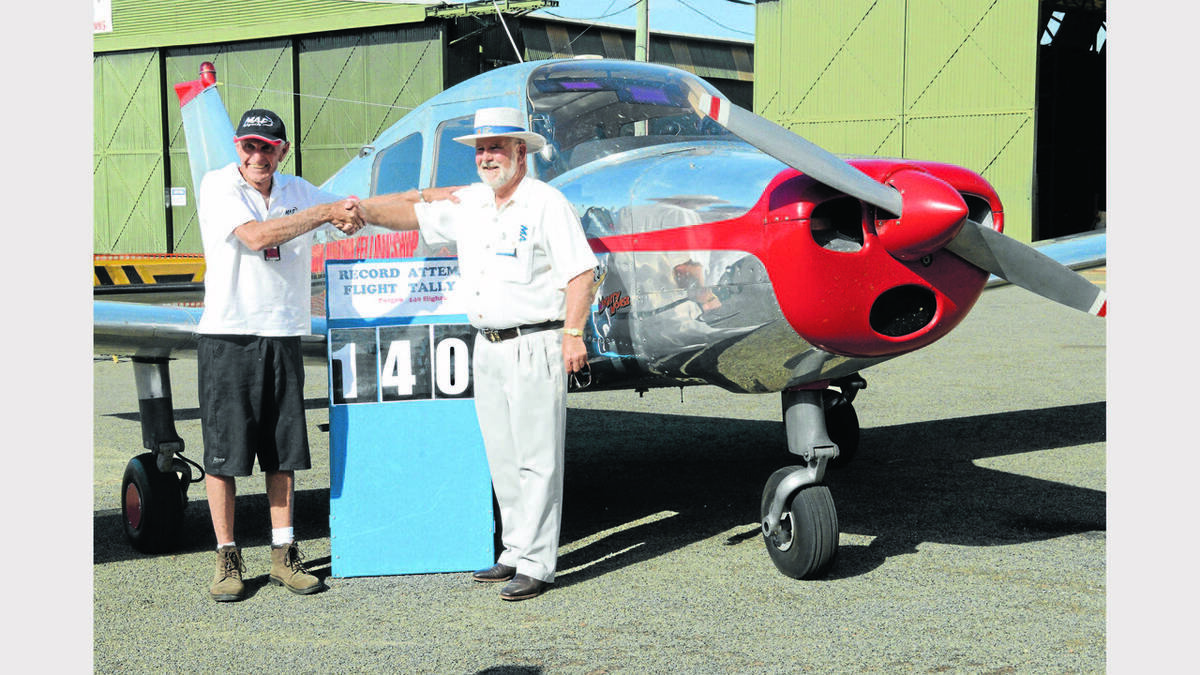 Parkes Mayor, Ken Keith congratulates pilot Ron Watts on setting the Australian record for the most number of flights