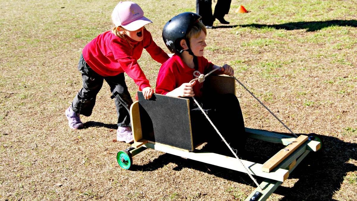 COWRA: Forget the Formula One, the fastest racing action could be found at Holmwood Public School’s Billy Cart Derby last Friday. Pictured Lilly Whitty charges Harry Beaumont onwards.