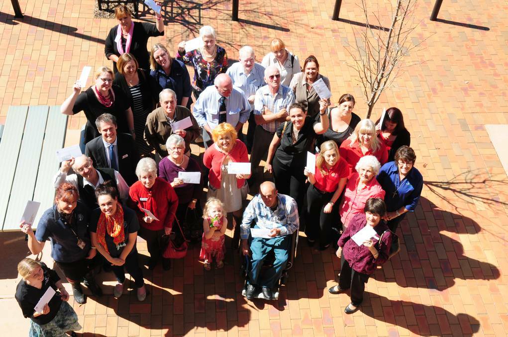 DUBBO: Grateful recipients of cash from Dubbo City Council s 2013/2014 Community Financial Assistance Program celebrate with mayor Mathew Dickerson. Photo: LOUISE DONGES