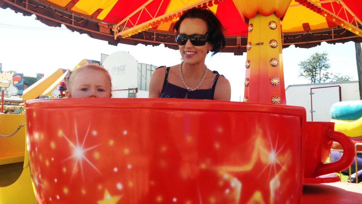 COWRA: Jacinta McKay takes a spin on the teacups with mum, Melissa Hunt.