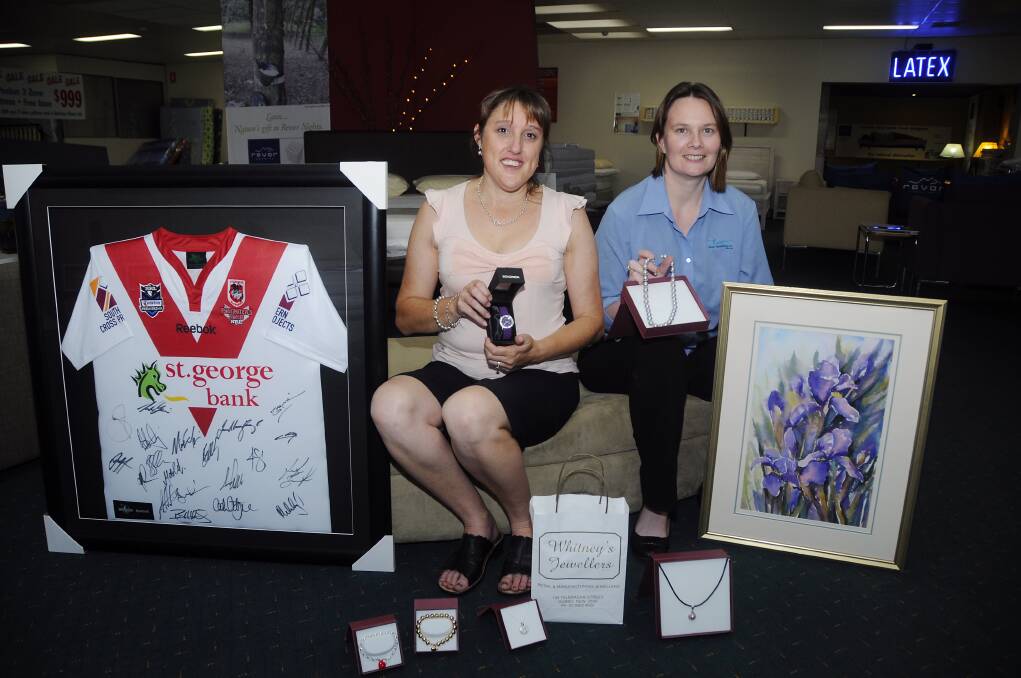 Hear Our Heart Ear Bus Project committee members Rachael Mills and Rowena Galway with the prizes up for sale via silent auction on Facebook. Photo: BELINDA SOOLE