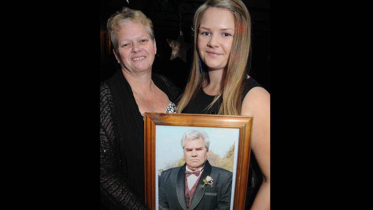 Debbie and Brittany Hill with a photograph of Max Hill