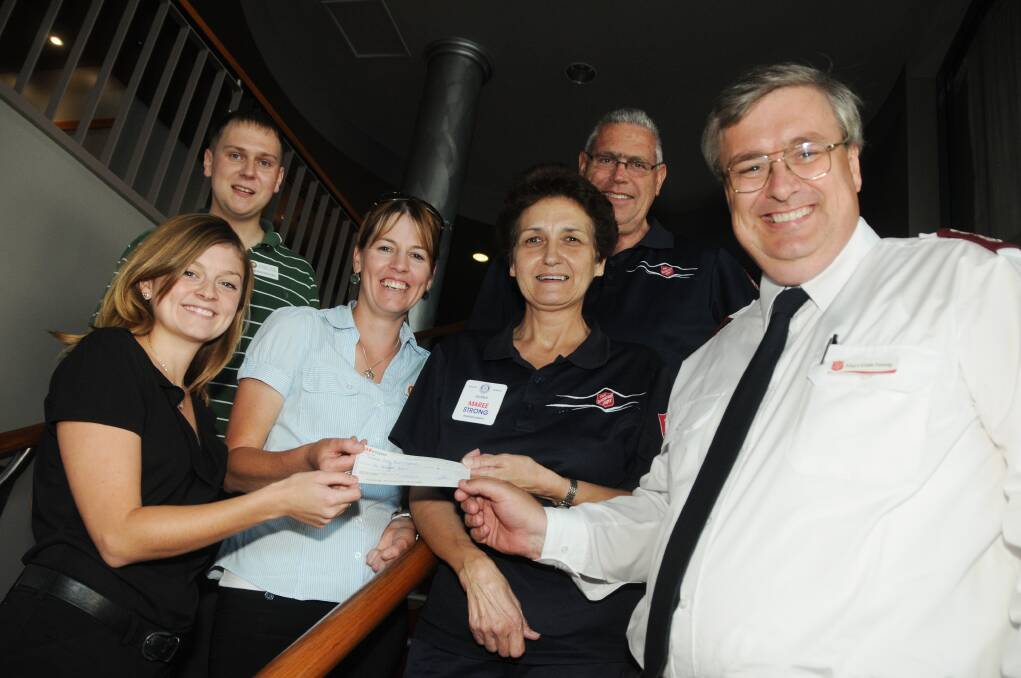 Jessica Smith, Andrew Brooks and Carla Pittman of Rotaract Dubbo hand over a $1000 cheque to the Salvation Army's Maree and Trevor Strong and Major Colin Young. Photo: AMY MCINTYRE