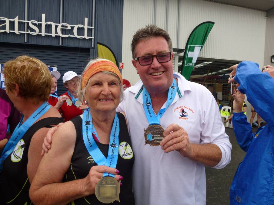 Dubbo Outback Dragon Boat Club paddlers Allaine Duncan and Graeme Board with gold medals won at the Pan Pacific Masters Games held on the Gold Coast.