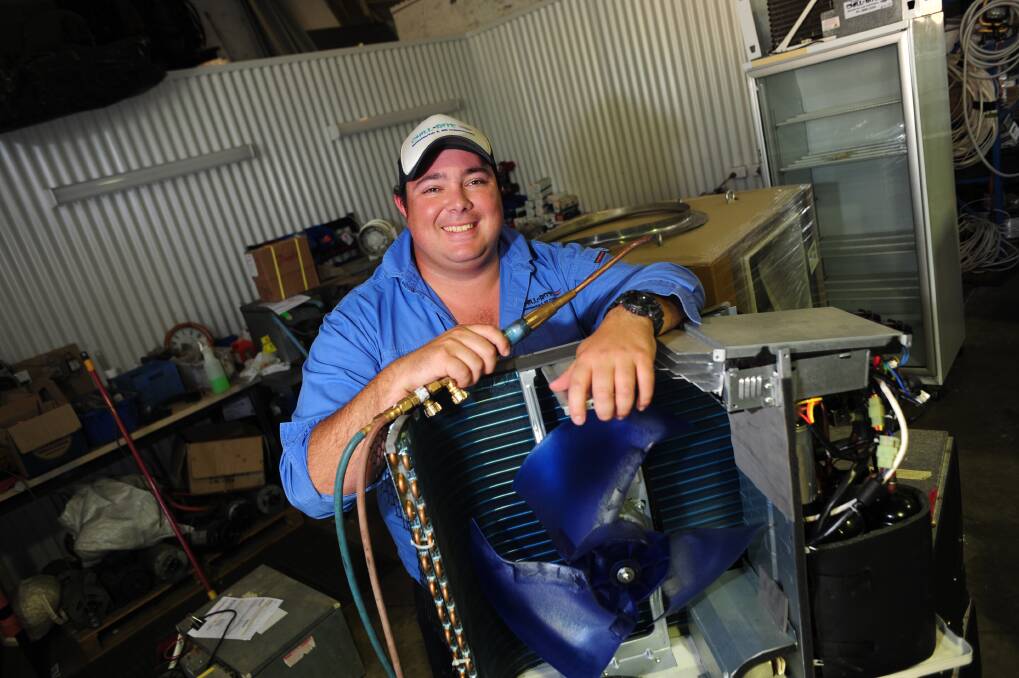 Chill-Rite director Luke Robinson with one of the air conditioners that has kept his Dubbo business busy since Christmas. Photo: LOUISE DONGES