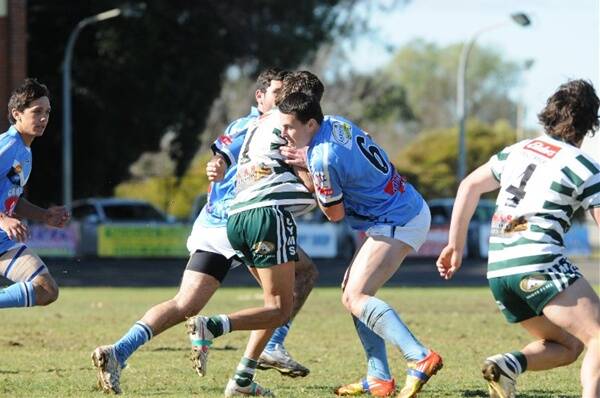 Swade Dunn does the hard work in defence for Macquarie under-18s in the recent local derby at No.1 Oval. Photo: CHERYL BURKE