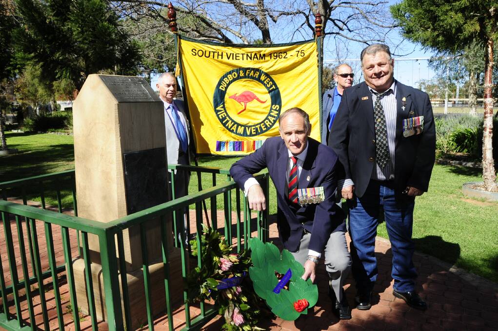 Trevor Lees and Neale Brooks hold the banner for the Dubbo and Far West Region Vietnam Veterans Association near the memorial with vice-president Greg Salmon and president Bert Eade. 	              Photo: BELINDA SOOLE