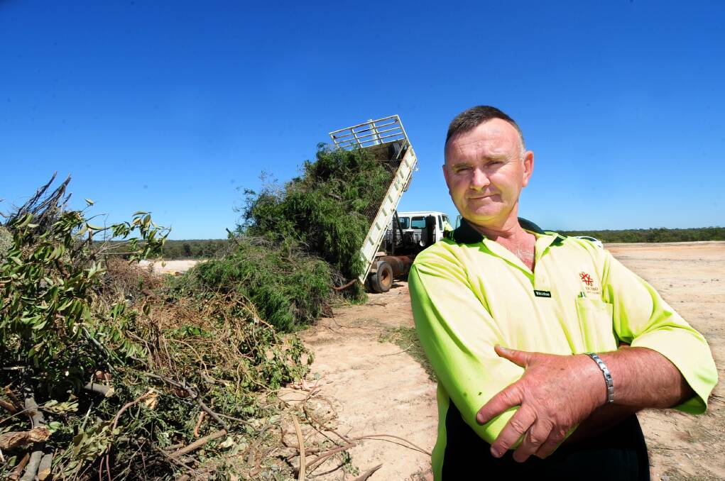  Whylandra Waste and Recycling Centre employee Allan Andriske adding to the city’s green waste pile. Photo: LOUISE DONGES.