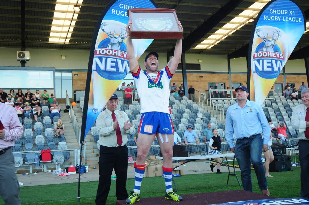 Pat Rosser hoists the premiership trophy after Parkes' win over CYMS yesterday.					             Photo: CHERYL BURKE
