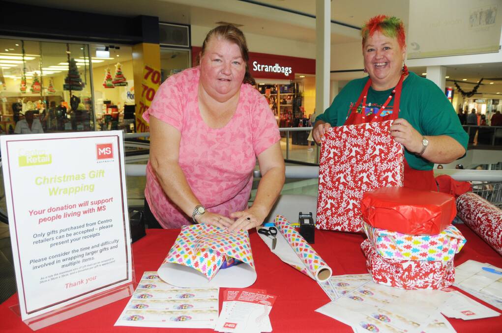 Michelle Coughlin and Cathy Neely at Centro wrapping gifts for customers to raise money for MS Australia. Photo: AMY McINTYRE