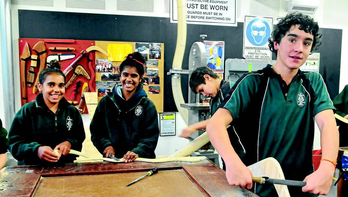 ORANGE: Canobolas Rural Technology High School students Jada Murphy, Brianne Wise, Jai Kelly and Tyson Tweeddale get down to their roots while making boomerangs. Photo: JUDE KEOGH 0522indig1
