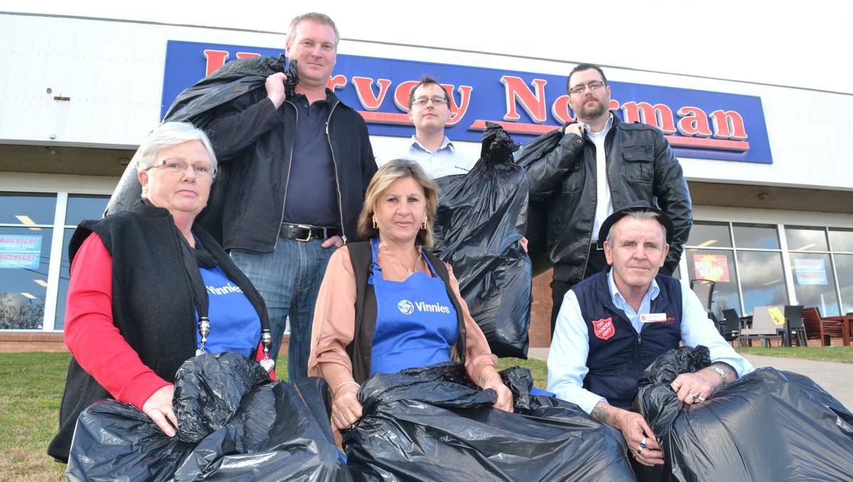 BATHURST: Ben Bradley, Andrew Smith and Michael Boyd from Harvey Norman Kelso (back) and Jenny Cini and Sandra Peckham from Vinnies and the Salvo's Steve Barrott (front) are all urging the Bathurst community to fill garbage bags with gently- used winter clothing and donate them at Harvey Norman this Saturday to receive a discount. Photo: BRIAN WOOD 052813harvey