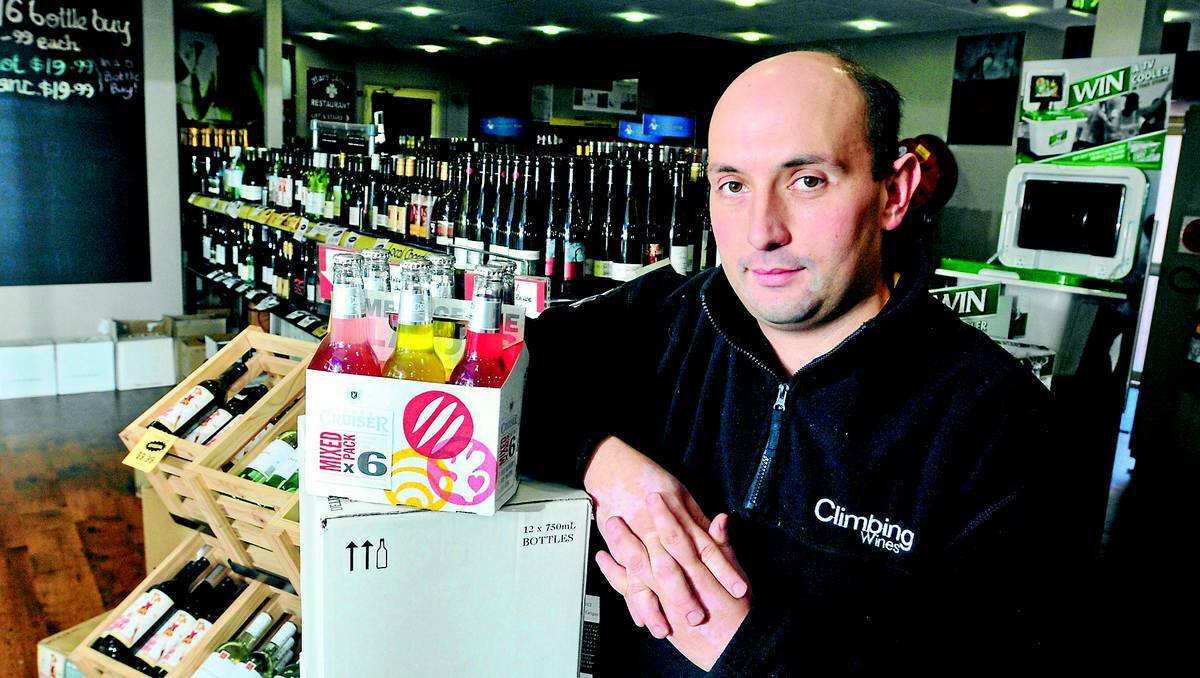 ORANGE: THE alcopop tax has done nothing to curb teen binge- drinking according to a study. Kelly’s Rugby Hotel bottleshop attendant George Eleftheriou with the not-so popular ready-to-drink beverages. Photo: JUDE KEOGH 0527alcopops