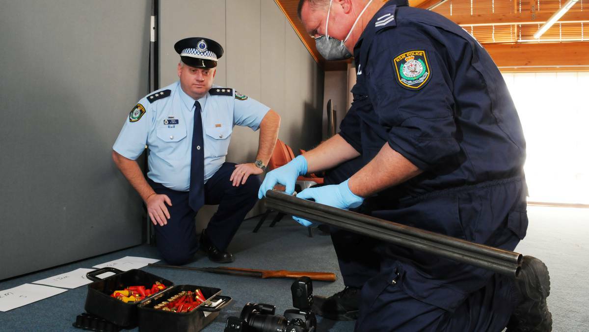 BATHURST: Detective Acting Inspector Gareth Smith with Senior Constable Cameron Wells, a forensic officer attached to Bathurst Crime Scene, during Monday’s weapons seizure. Photo: ZENIO LAPKA 080513zguns