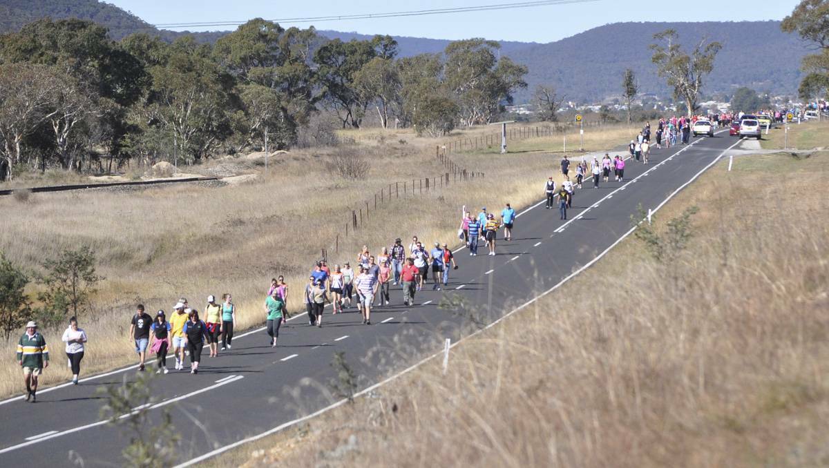 LITHGOW: Pipers Flat Road turned into a footpath for walkers in the Walk for Cancer fundraiser held on Sunday. lm052813walk