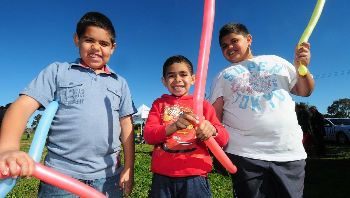 Brothers with balloons at the NAIDOC event in Dubbo on Friday are Dre Lang, Jermaine Carr and Jasong Lang.