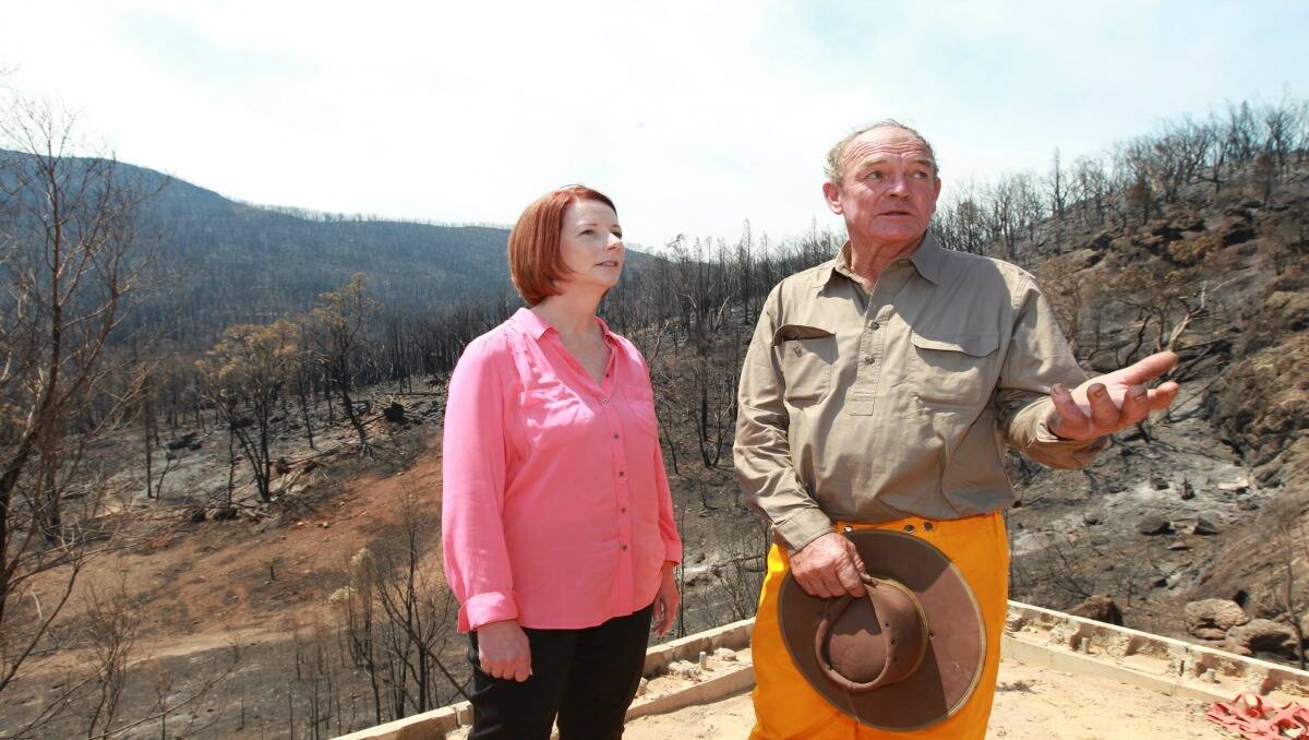 PM Julia Gillard with Bob Fenwick who lost his home during the fires in Coonabarabran. Photo taken on January 17th. Photo: JACKY GHOSSEIN