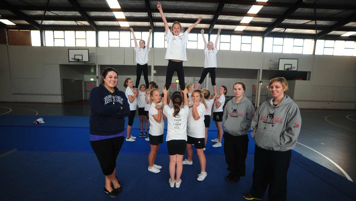 DUBBO: Dubbo Cheer Academy members Hannah Macleod, Mariah Delaney and Paris Wall are held aloft by squad members under the watchful eye of coaches Amy Mawby, Kendy Beasley and Danielle Fistr. Photo: BELINDA SOOLE