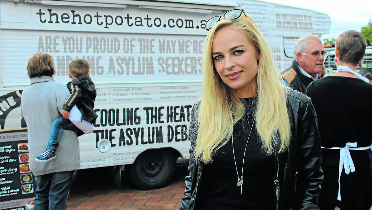 MUDGEE: Ambassador for the Asylum Seeker Resource Centre Imogen Bailey stands in front of The Hot Potato van at the Farmers Markets on Saturday. Imogen and the Hot Potato van will travel to Brisbane to bust several widely held asylum seeker myths.