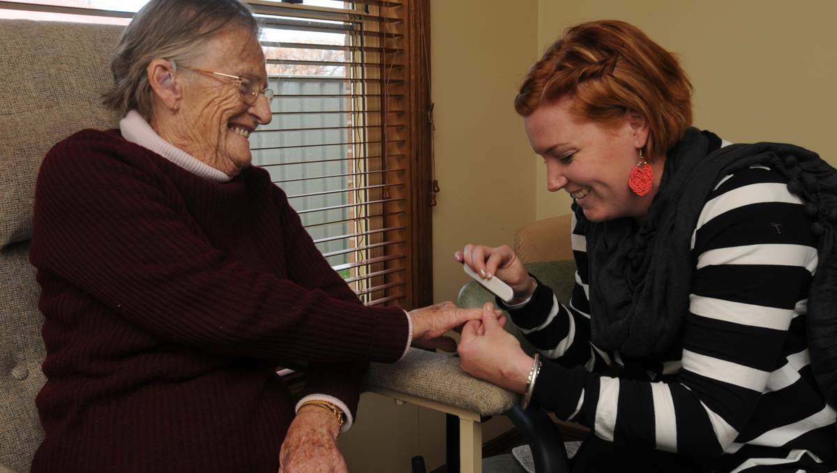 Sarah Sheldon (right) volunteers her time to help dementia sufferers like Erma Phillips as her own mother suffers from the syndrome. Photo: STEVE GOSCH 0528sgmaple1