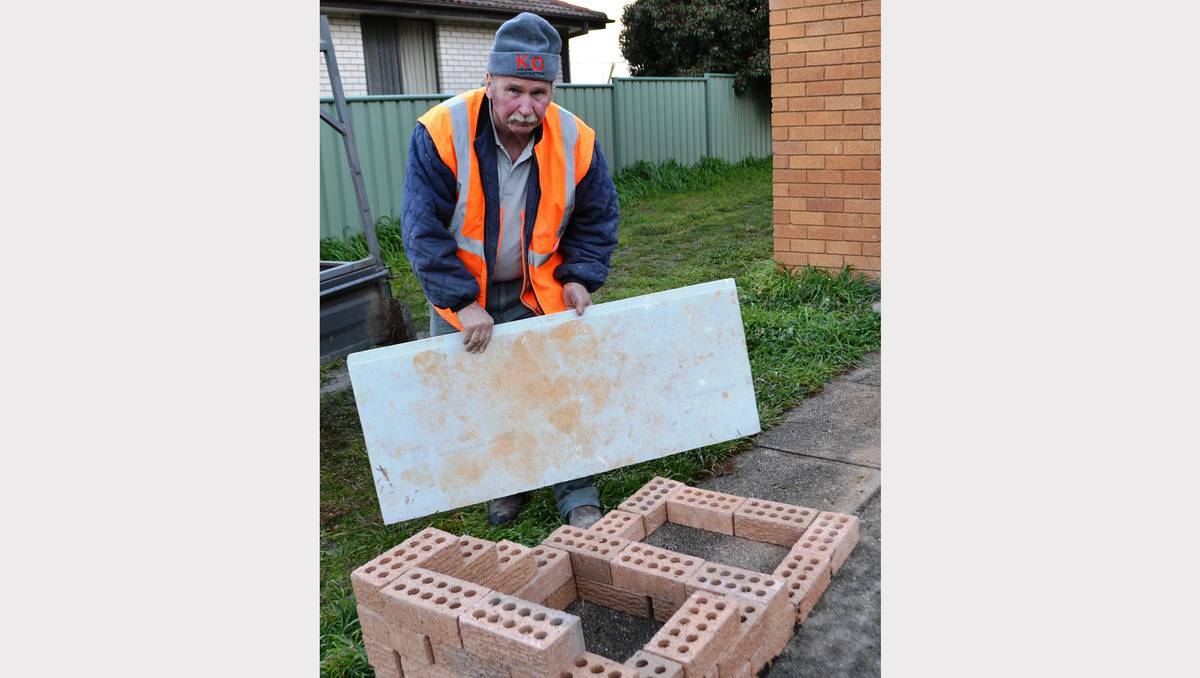 Blayney builder Peter Hildenbeutel shows how easy it is to set up composting in a few minutes using bricks to create bays about one metre square to place organic waste into, then topping with either a fibreboard or piece of tin not plastic.
