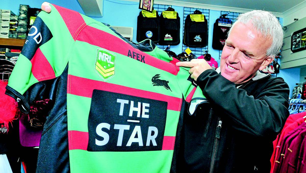 ORANGE: Willoughby’s Model Cars owner Paul Willoughby with an NRL jumper advertising gambling. He believes the amount of live gambling ads on TV is “disgusting” and welcomes Prime Minister Julia Gillard’s push to ban it. Photo: JUDE KEOGH 0527gamble2