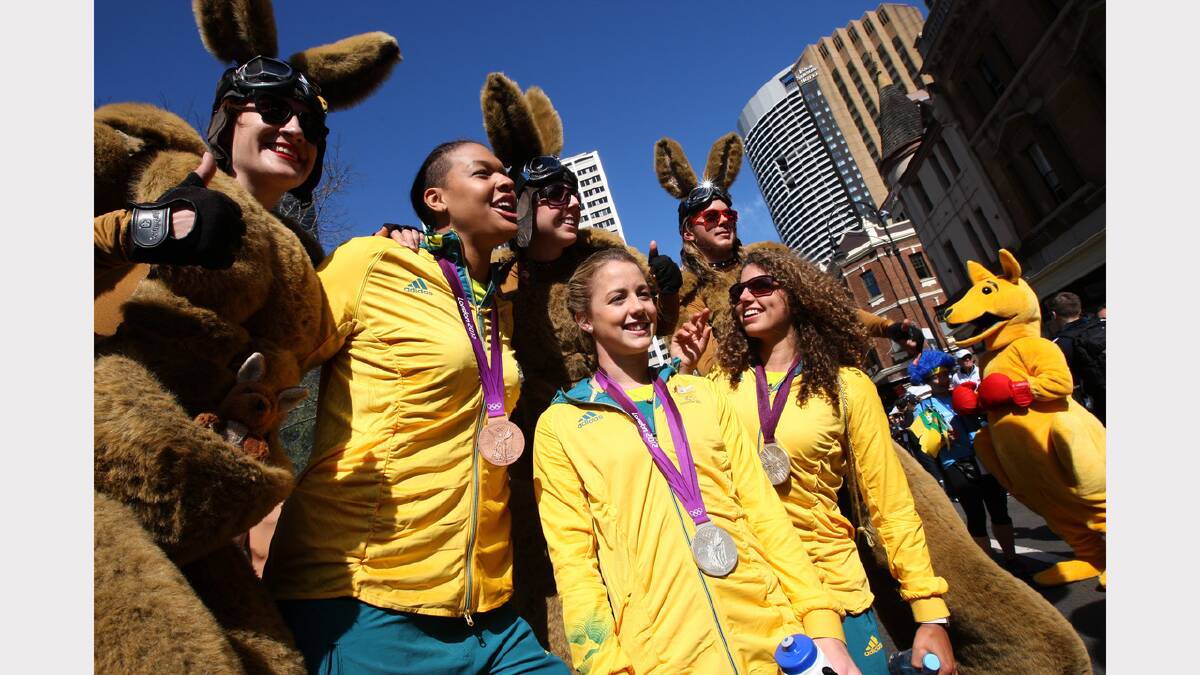 Liz Cambage, left, Brittany Broben, centre, and Jessica Fox during the welcome home to the Australian Olympians parade down George Street, Sydney