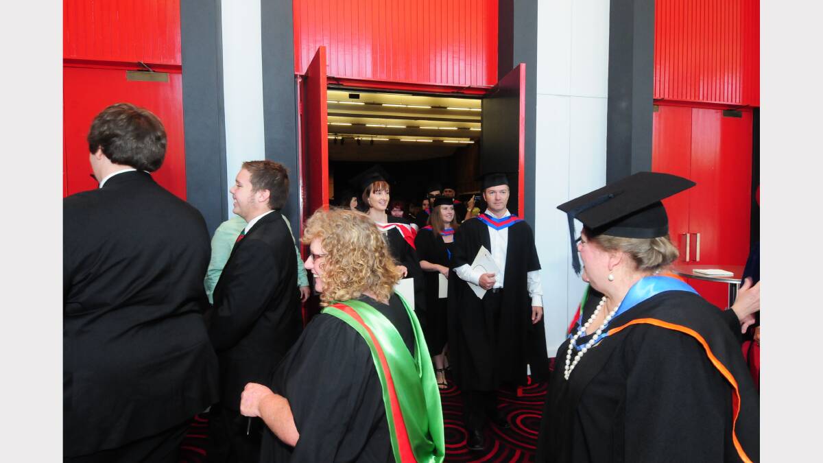 Recently graduating students leave the convention centre. 