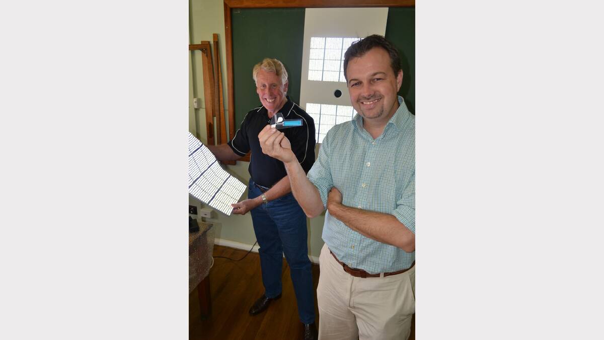 Southern Cross Printed Electronics chief executive officer Peter Simons with a printed LED sheet and the company's chief financial officer Simon Smith, who holds the prototype LED fishing lure. Photo: SIMON CHAMBERLAIN