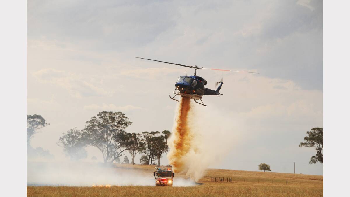 A fast-moving fire threatening property in West Dubbo was thwarted from the ground and the air late Wednesday afternoon. Police are investigating the cause of the fire.											            Photo: AMY MCINTYRE