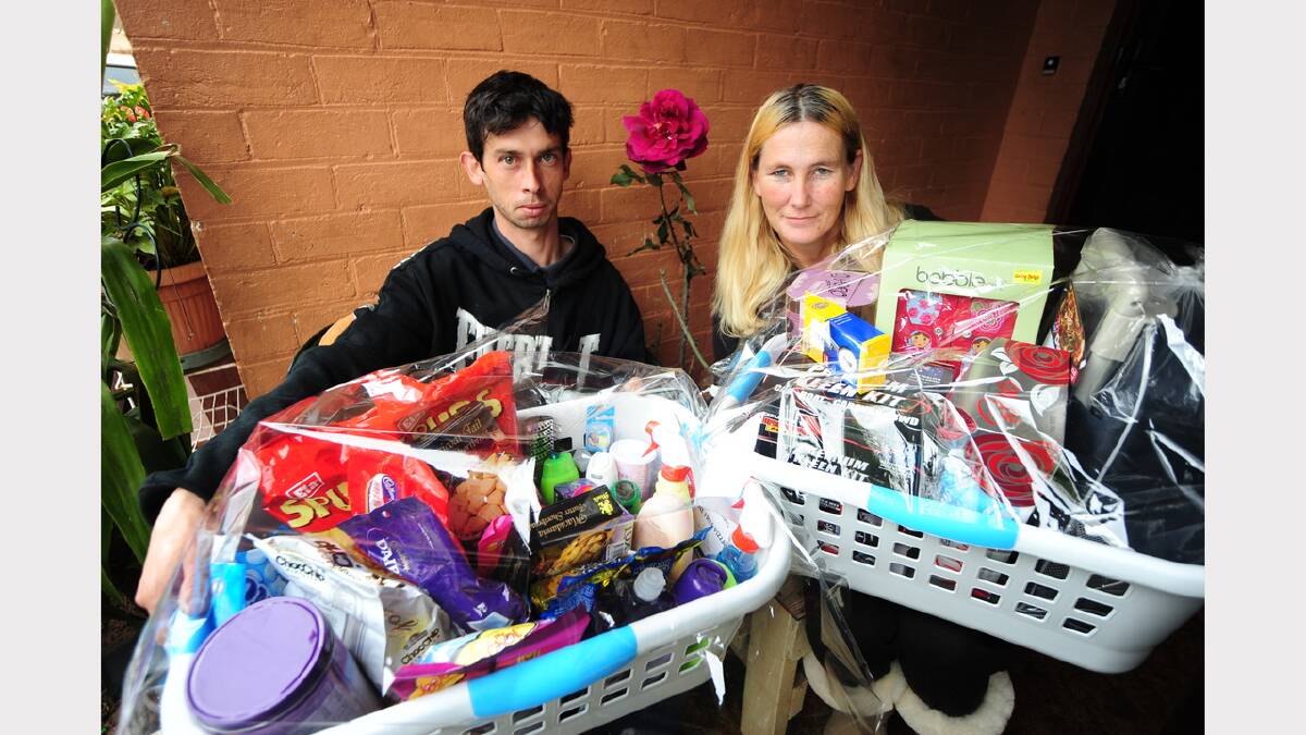 Arthur Smart, brother of Alois Rez who police allege was murdered, and family friend Frances McIntosh with hampers prepared as raffle prizes for today's fundraising event at the Dubbo RSL Memorial Club car park. Photo: BELINDA SOOLE