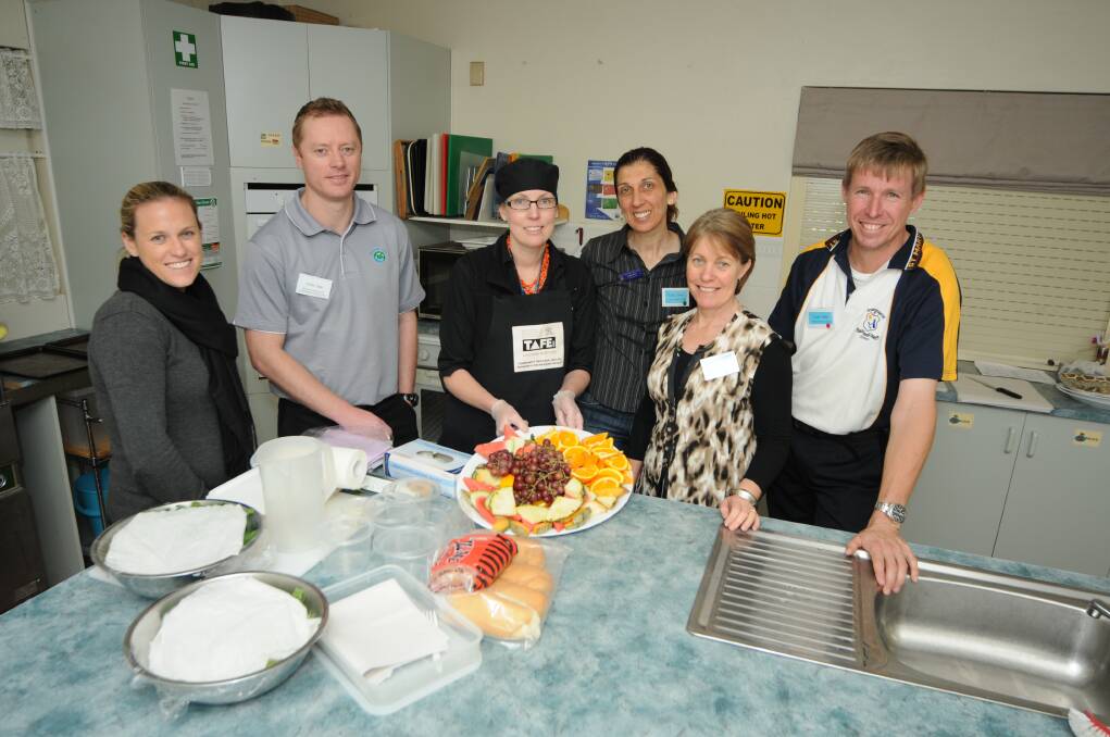 Talking healthy food at the school canteen expo are Lauren Lynch, Chris Tate, Melissa Baxter, Cathy Dries, Julie Smith and Colin Willis.  Photo: BELINDA SOOLE