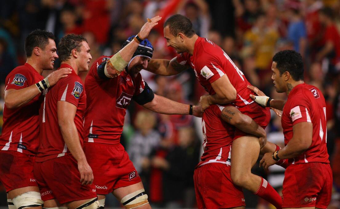 Quade Cooper of the Reds celebrates victory with team mates in the round 14 Super 14 match between the Reds and the Highlanders at Suncorp Stadium on May 15, 2010 in Brisbane, Australia. Photo by Jonathan Wood/Getty Images