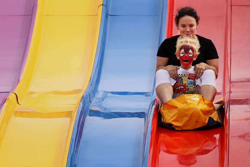 Sydneysiders take on the 'Super Slide' at the Sydney Royal Easter Show in Sydney, Australia. Photo by Lisa Maree Williams/Getty Images