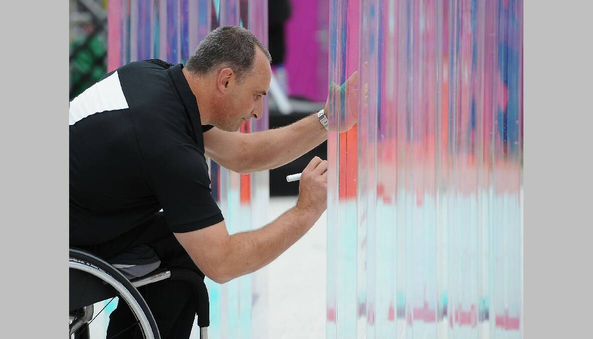 Chef De Mission, Duane Kale of New Zealand signs the 'wall of Good Wishes' during the New Zealand Flag Raising Ceremony at the Olympic Park on August 27, 2012 in London, England. (Photo by Christopher Lee/Getty Images)