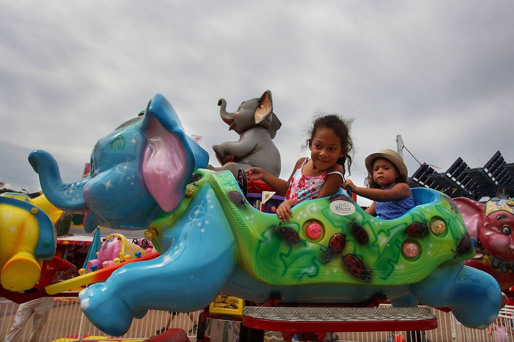 Young girls take to the rides at 'Side Show Alley' during the Sydney Royal Easter Show in Sydney, Australia. Photo by Lisa Maree Williams/Getty Images