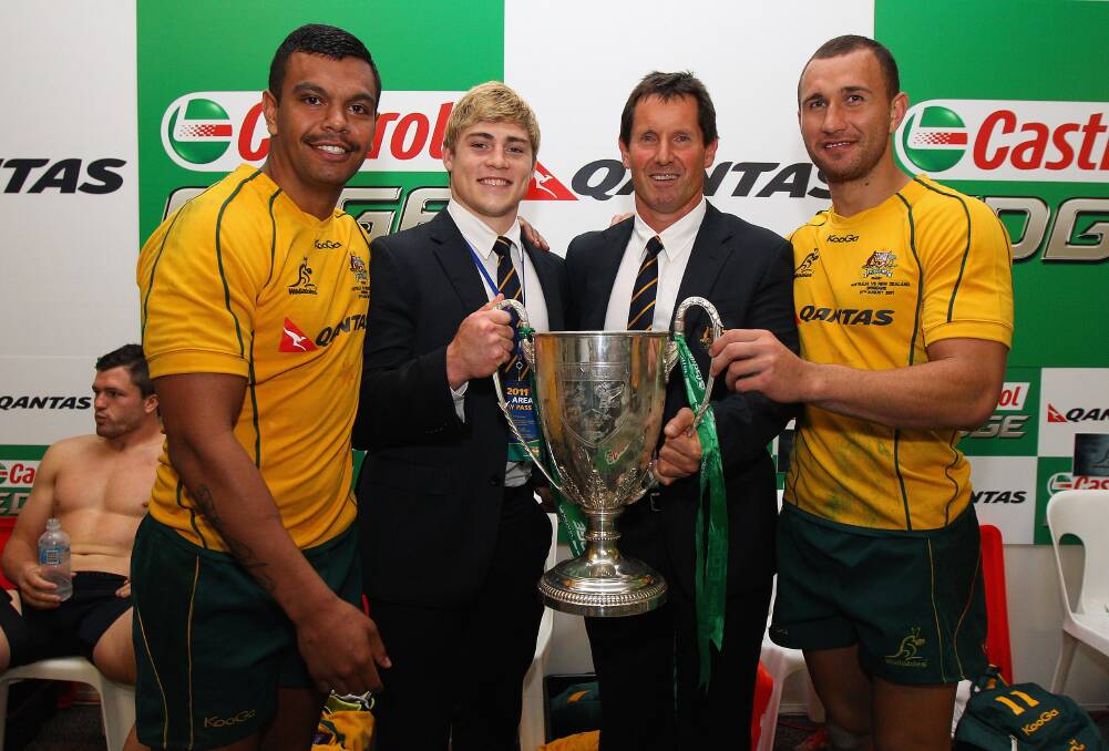 Kurtley Beale, James O'Connor, Wallabies coach Robbie Deans and Quade Cooper of the Wallabies pose with the Tri-Nations trophy after winning the Tri-Nations Bledisloe Cup match between the Australian Wallabies and the New Zealand All Blacks at Suncorp Stadium on August 27, 2011 in Brisbane, Australia. Photo by Cameron Spencer/Getty Images