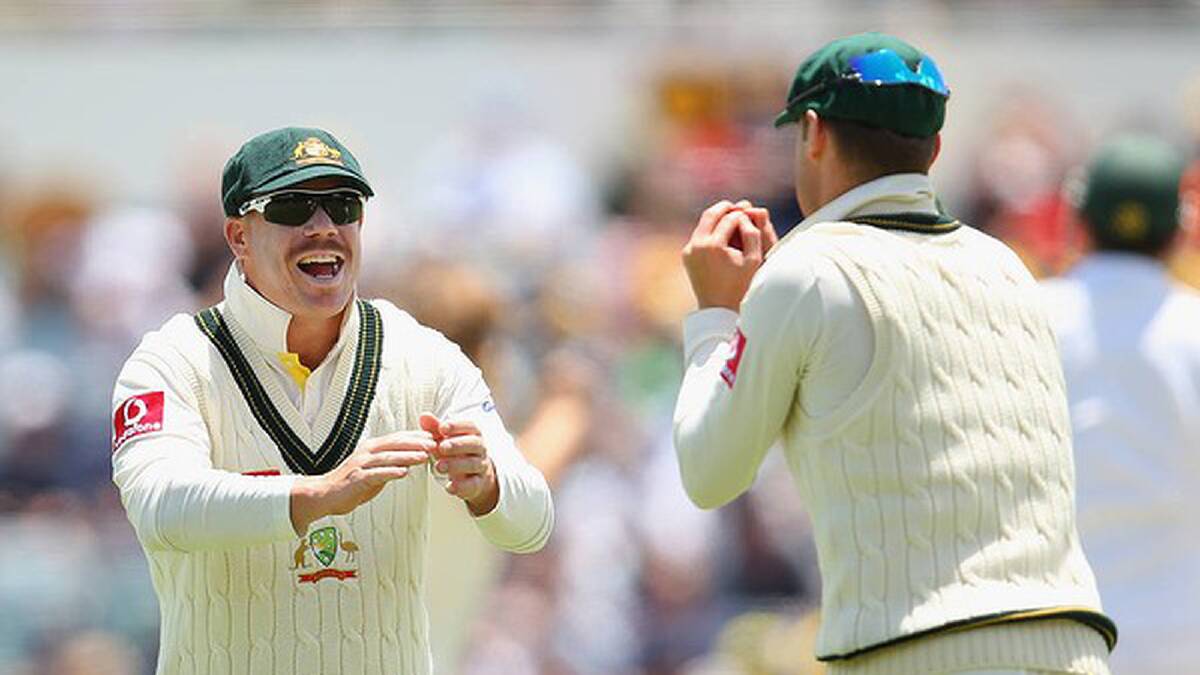 David Warner of Australia celebrates with Michael Clarke after his captain caught Graeme Smith. Photo: Getty Images