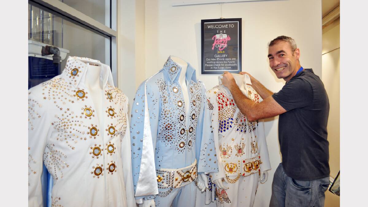 Greg Page makes some adjustments to some of the Elvis suits at the King’s Castle collection. 
