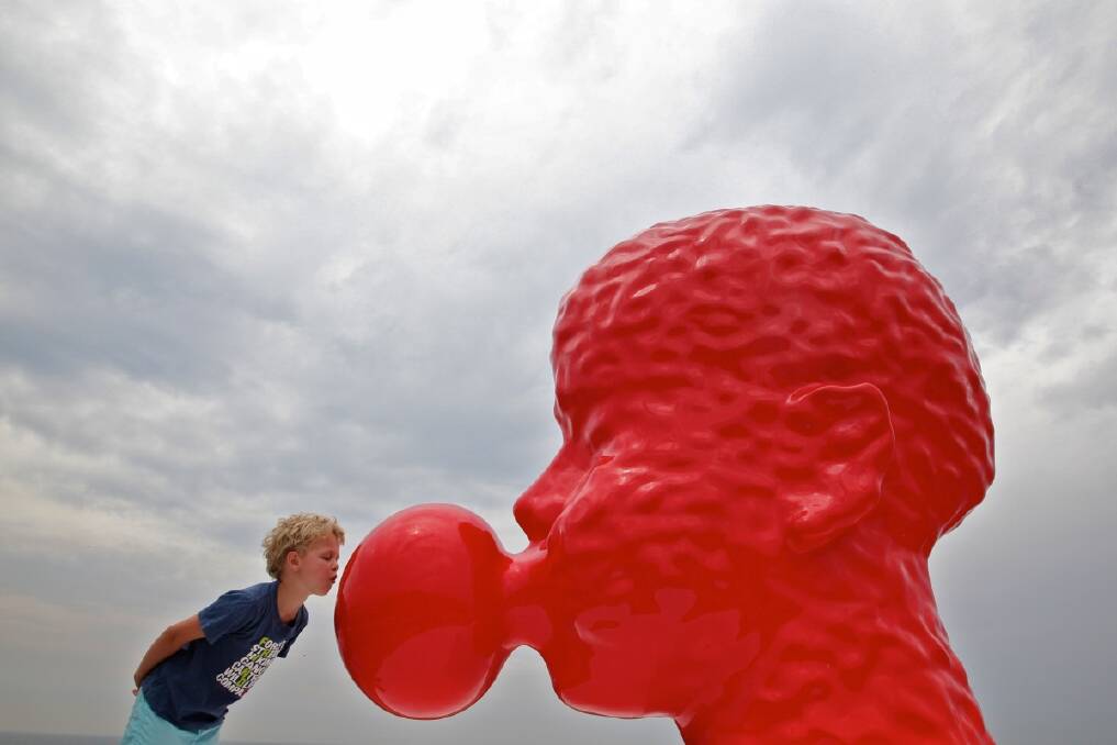 Otto French, age 6, from Melbourne with Qian Sihua's artwork no.5 Bubble, as part of the Sculpture by the Sea exhibition. Photo: Danielle Smith 