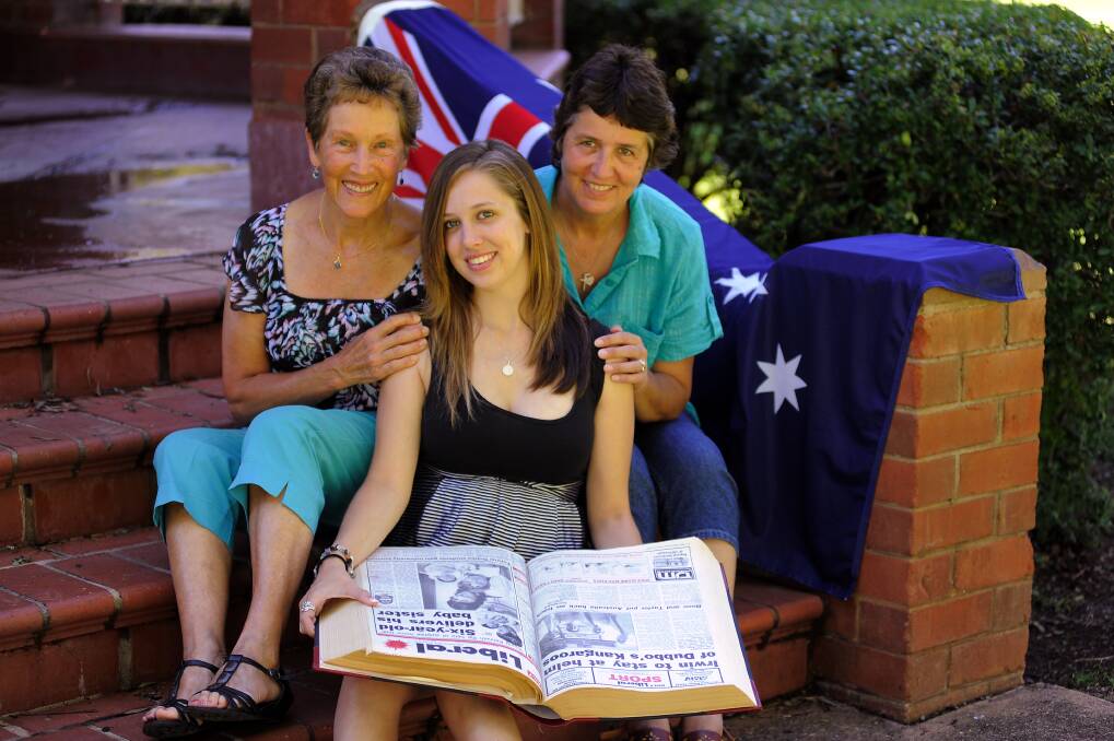 Grandmother Diana Jones, Australia Day birthday girl Sarah Rose and proud mum Raynor Jones look back at the front page of the Daily Liberal from 1992 which made headlines across the world. 							               	       Photo: BELINDA SOOLE