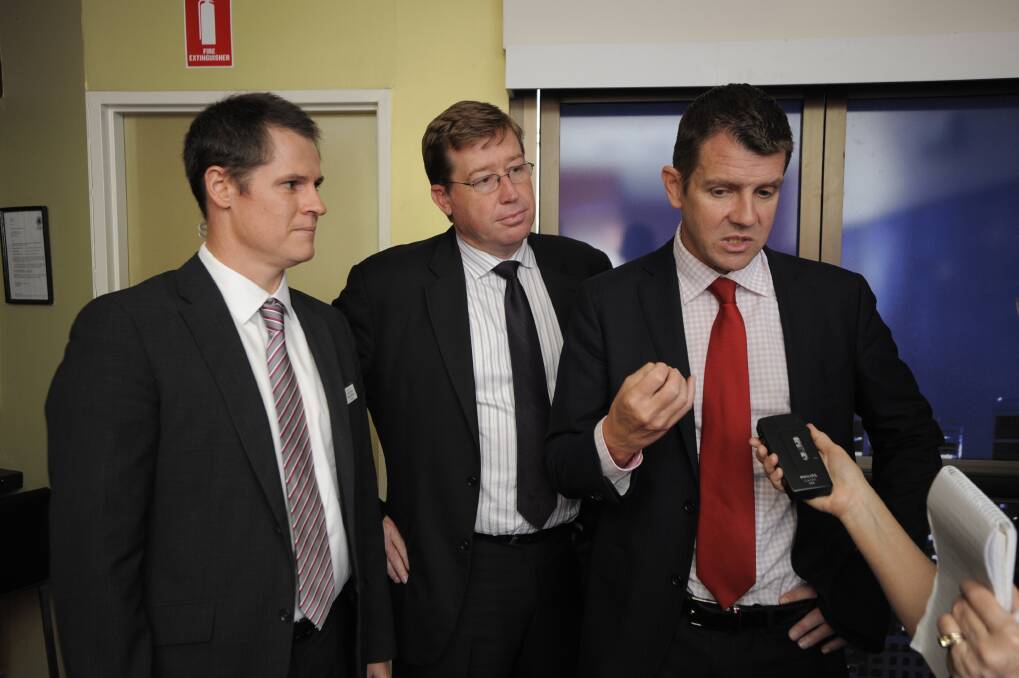 Dubbo mayor Mathew Dickerson and Dubbo MP Troy Grant listen to what NSW Treasurer Mike Baird has to say about the proposed Cobbora coal mine project. 	Photo: BELINDA SOOLE