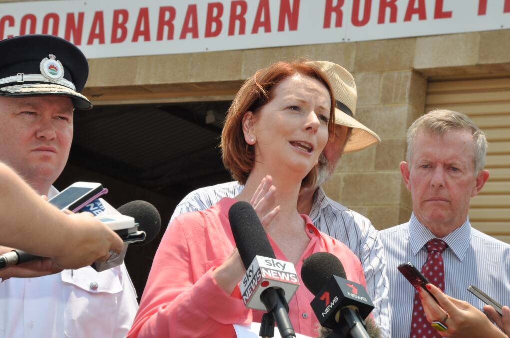 Prime Minister Julia Gillard flanked by NSW RFS Commissioner Shane Fitzsimmons and Parkes MP Mark Coulton, with the Warrumbungle Shire mayor, Peter Shinton partially obscured. Photo: LISA MINNER