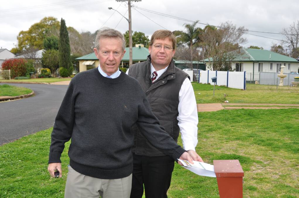 Mark Coulton and Troy Grant on their posting trail along West Dubbo streets. Photo: BELINDA SOOLE
