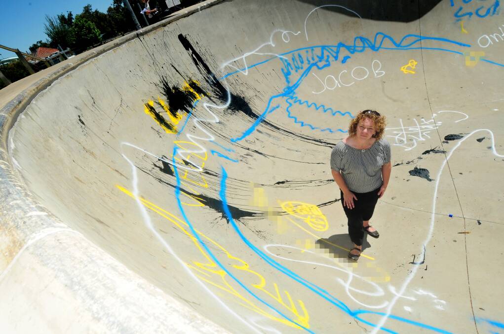 Graffiti left by vandals in the Dubbo Skate Park bowl is inspected by Dubbo City Council community participation facilitator Kathleen Oke. Photo: LOUISE DONGES