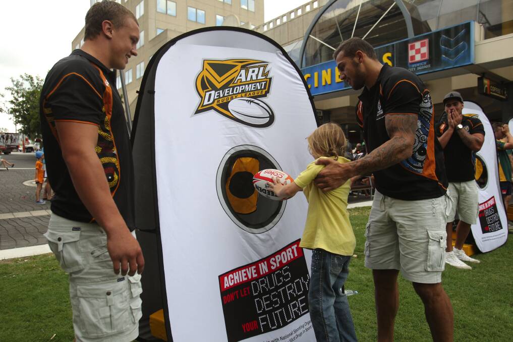Orange's Jack Wighton and Wellington's Blake Ferguson with a fan during a public appearance in the lead-up to Saturday night's NRL All Star match. Photo: NRL PHOTOS
